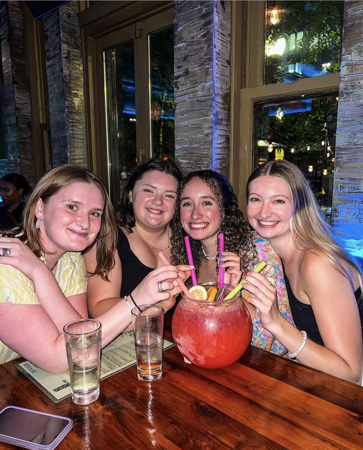 a group of people sitting at a table with wine glasses