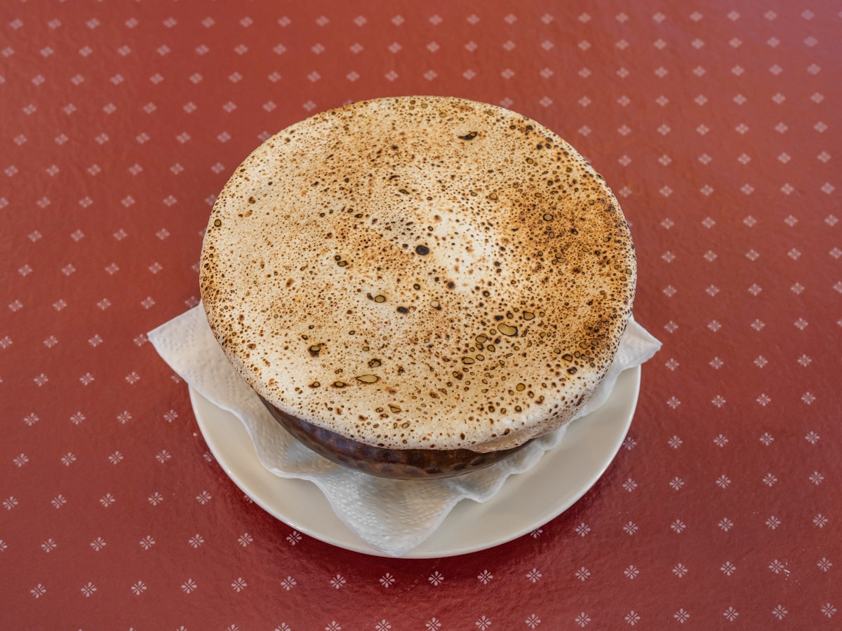a brown and white cake on a white plate