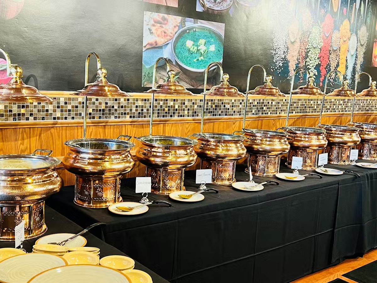 a table with many copper pots and plates