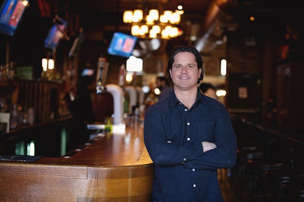 a man standing in front of a bar