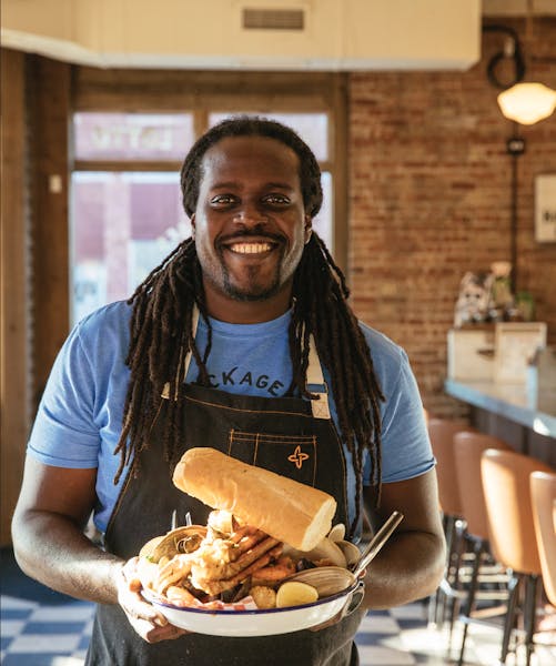 a person sitting at a table with a plate of food