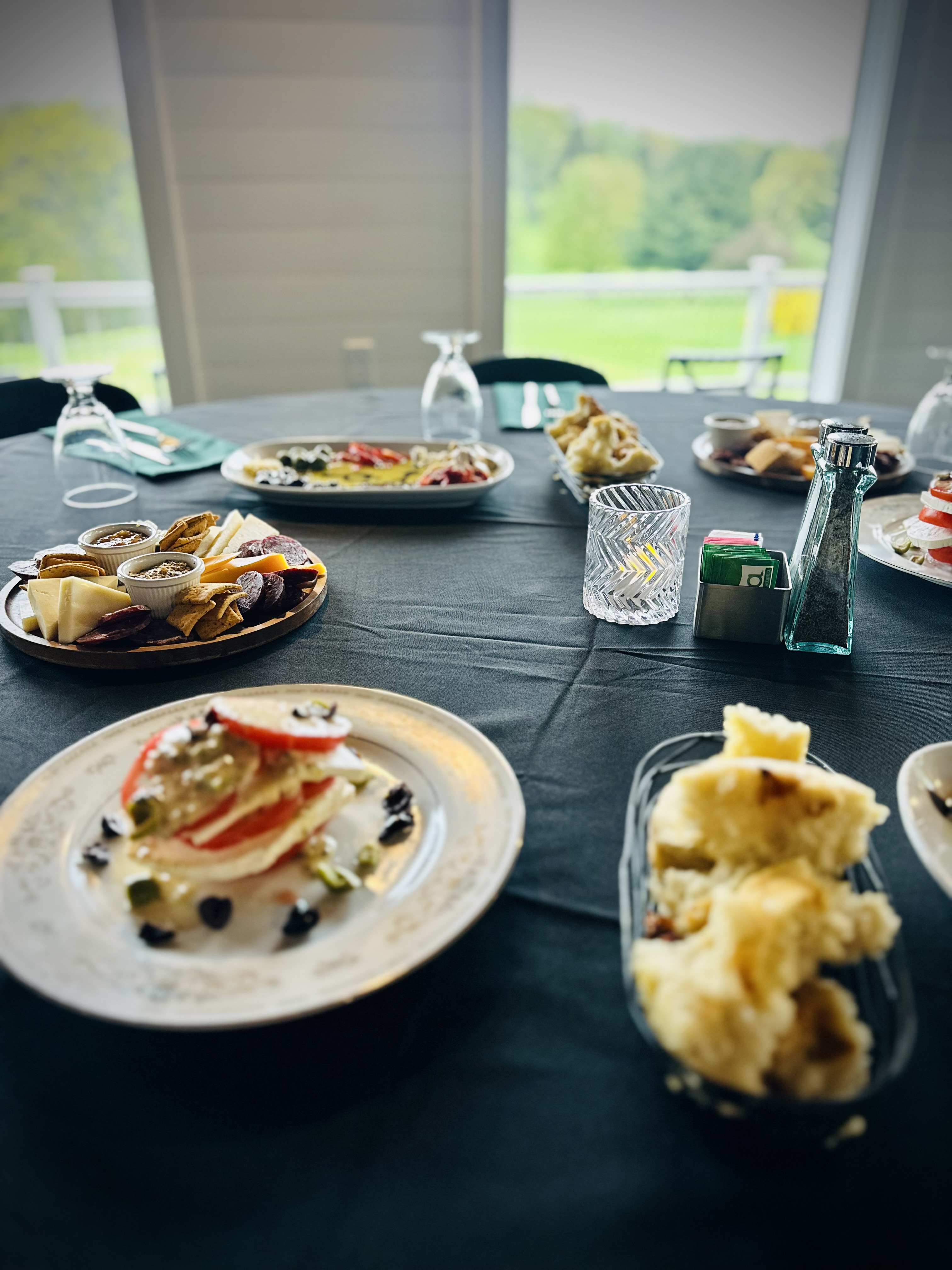 a group of people sitting at a table with a plate of food