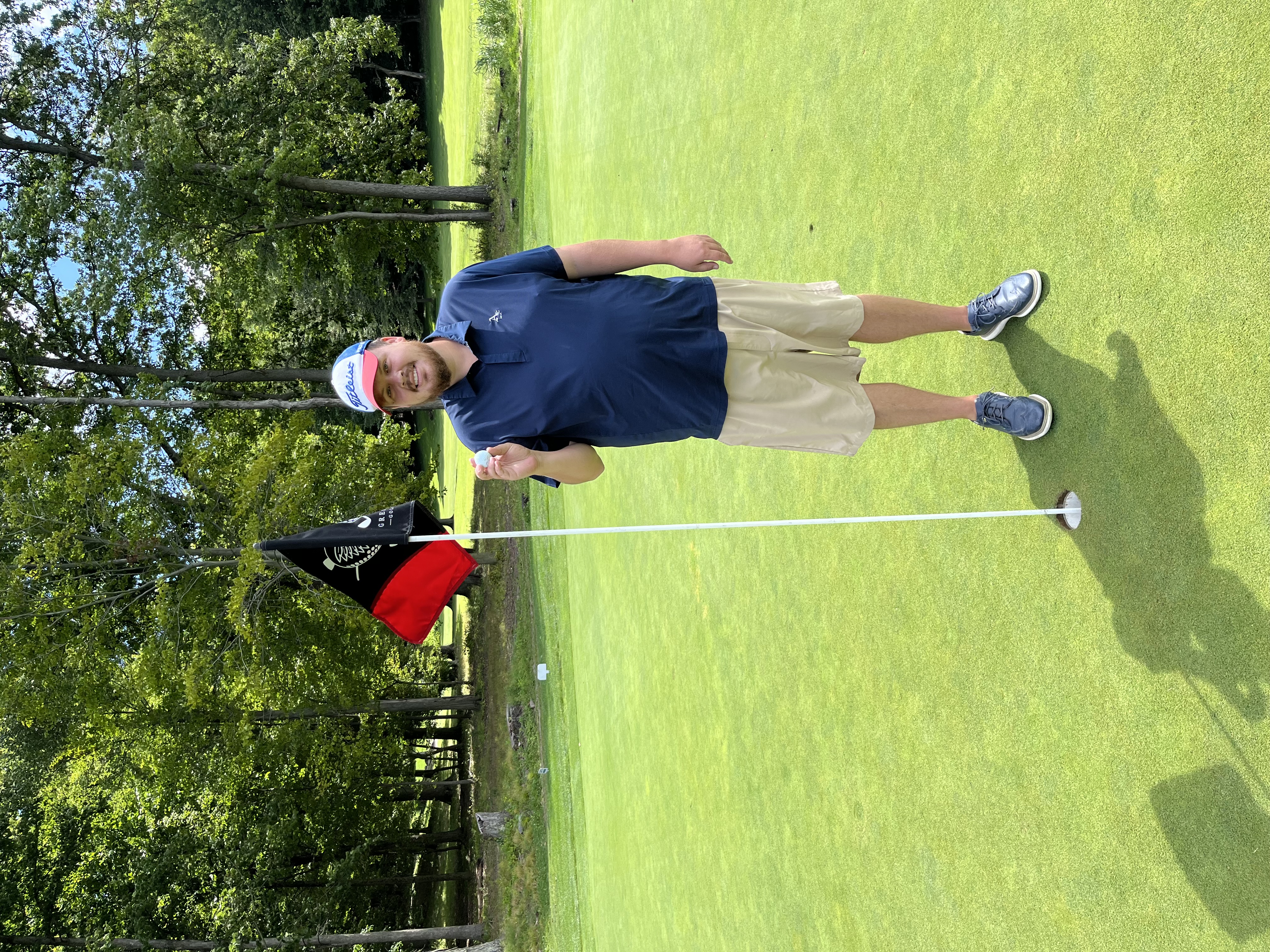 a man standing on top of a grass covered field