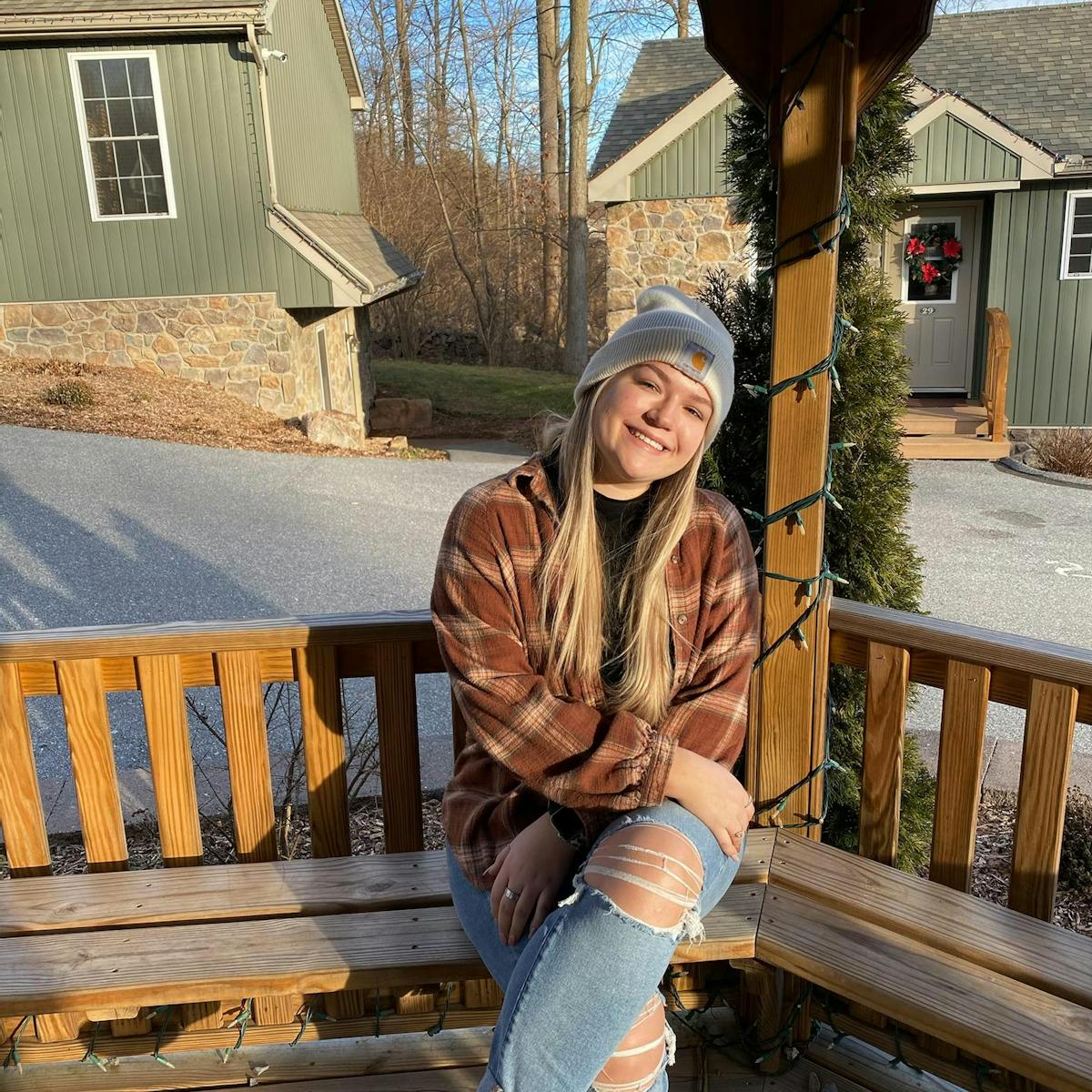 a person sitting on a bench posing for the camera