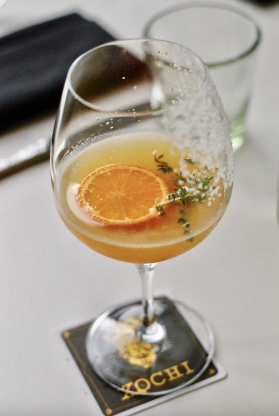 a glass of orange juice on a table