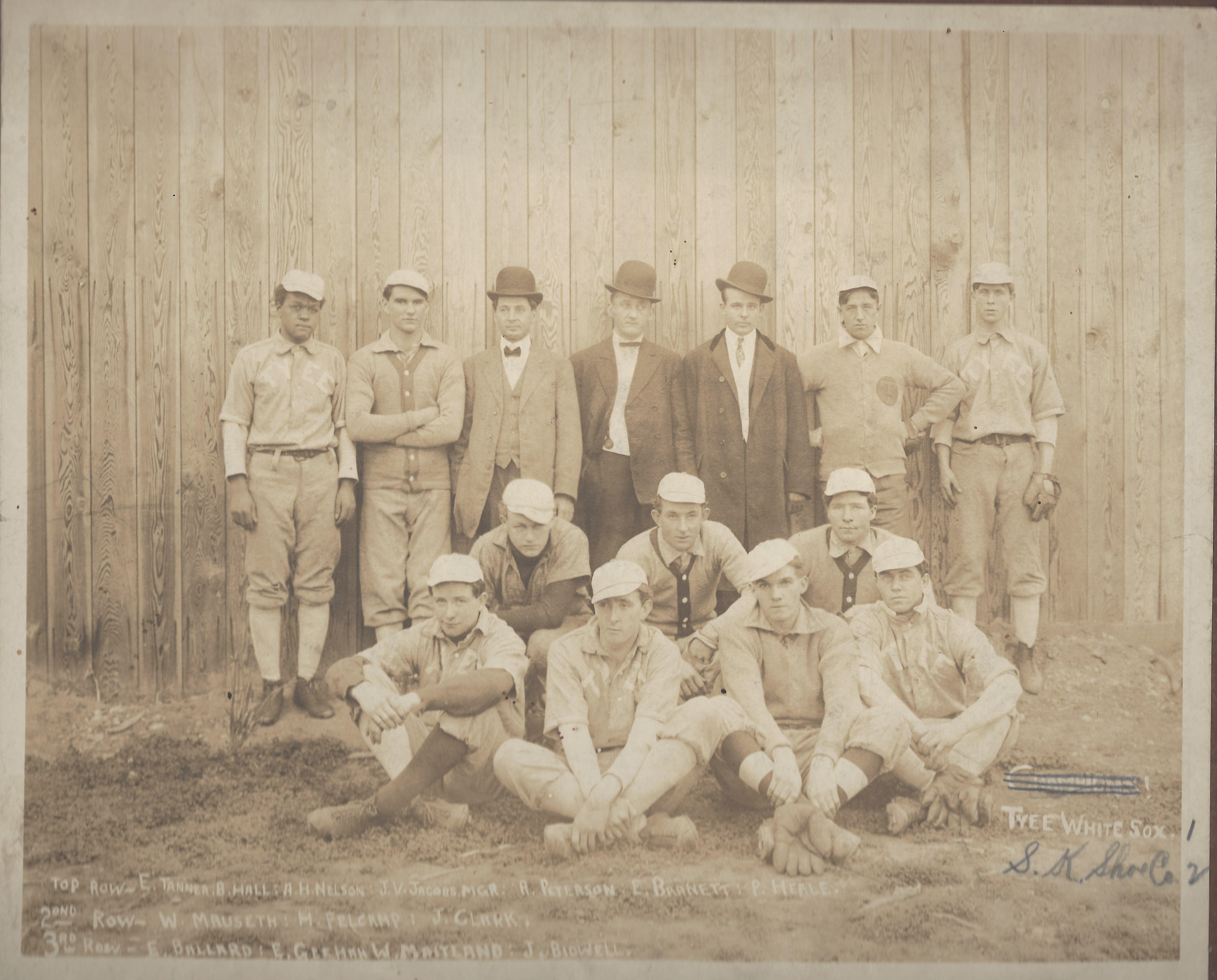 a vintage photo of a group of people posing for the camera