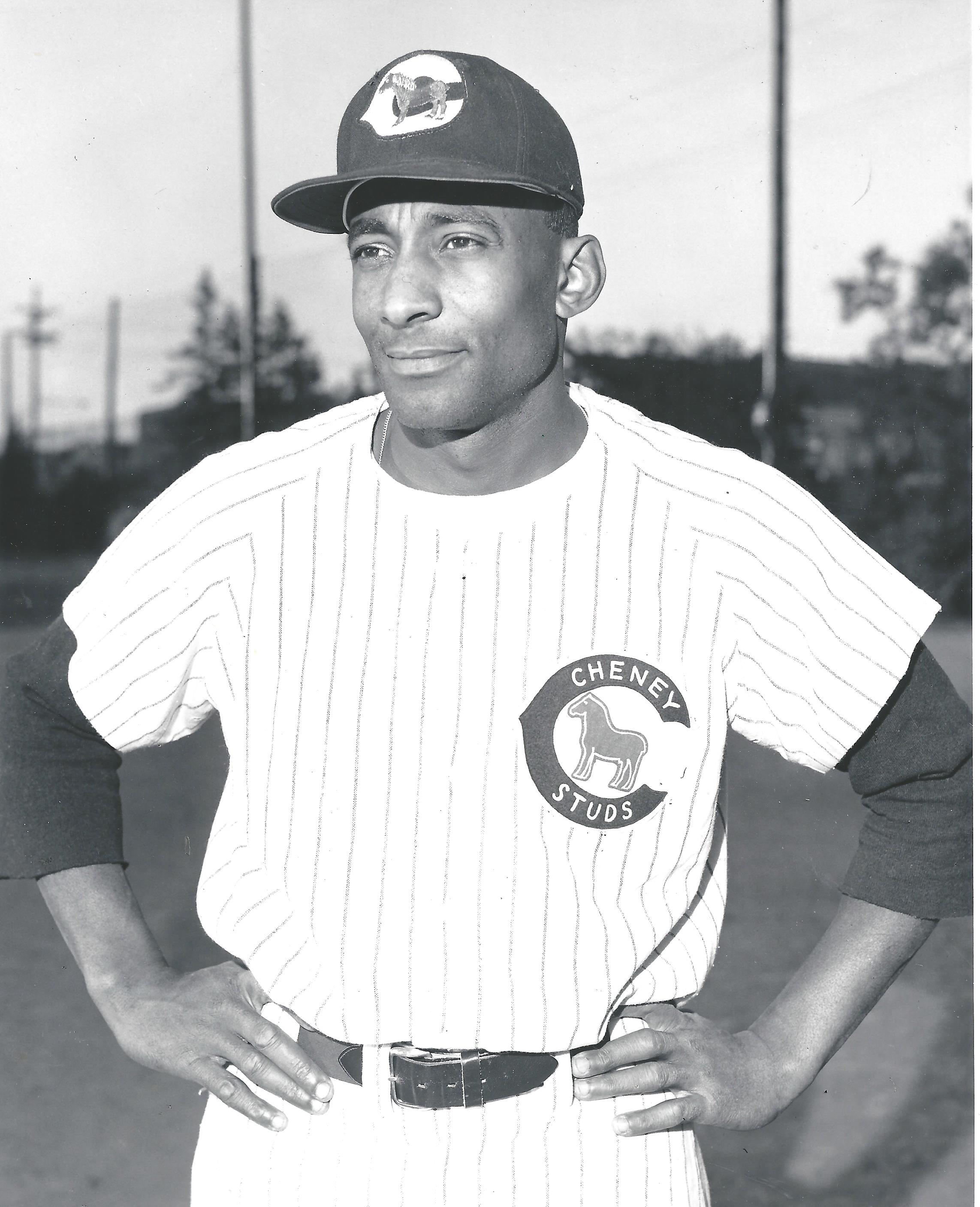 a man wearing a hat and holding a guitar