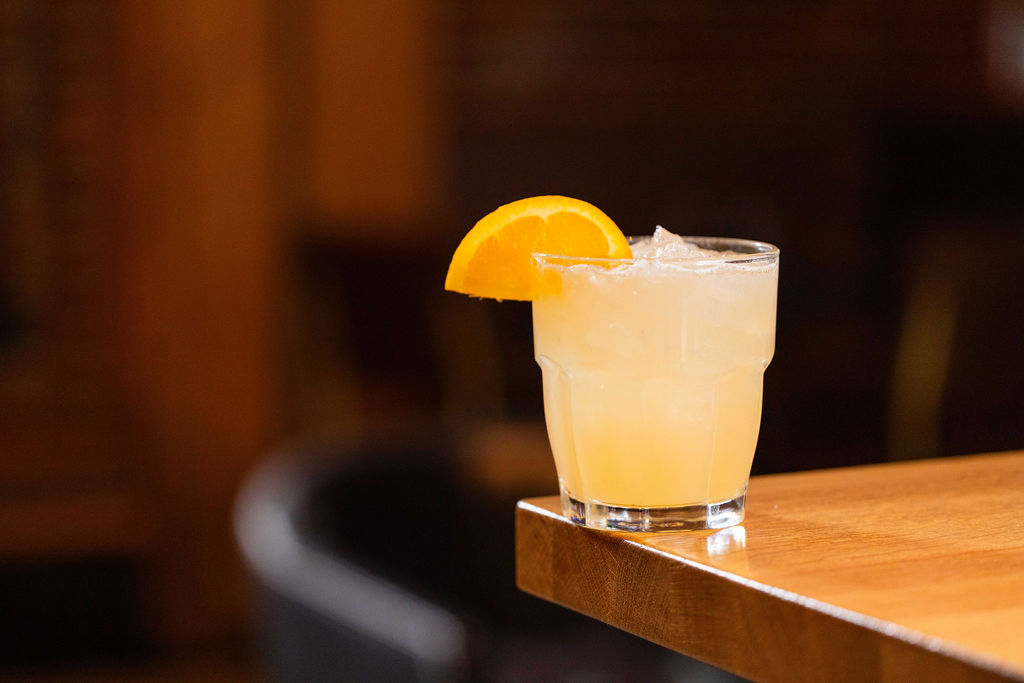 a cup of coffee sitting on top of a wooden table