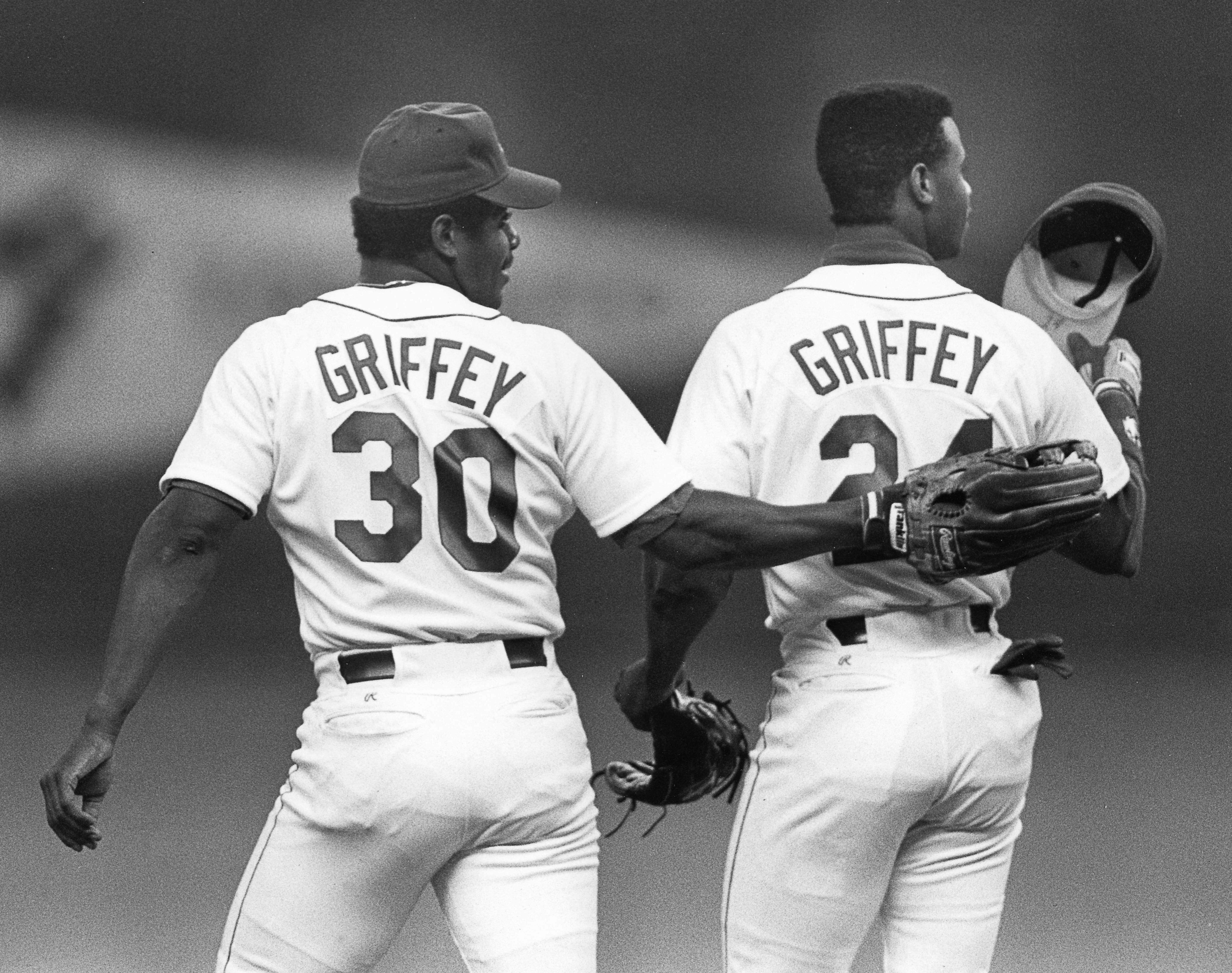 a group of baseball players standing on top of a field