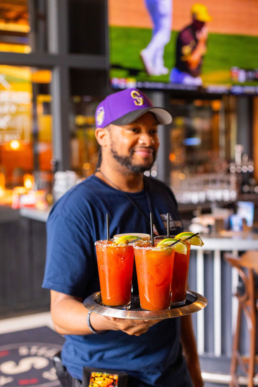 a person drinking a glass of orange juice