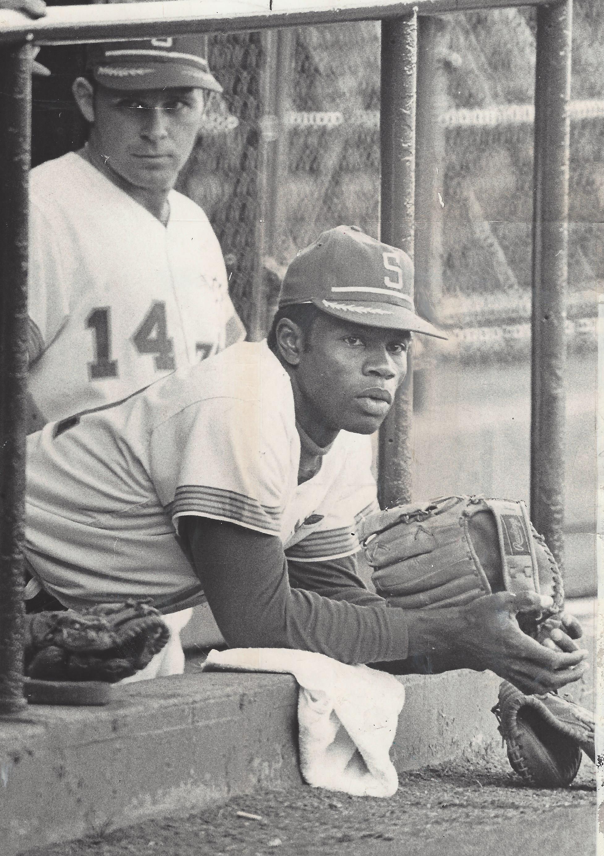 Tommy Harper sitting on a baseball field