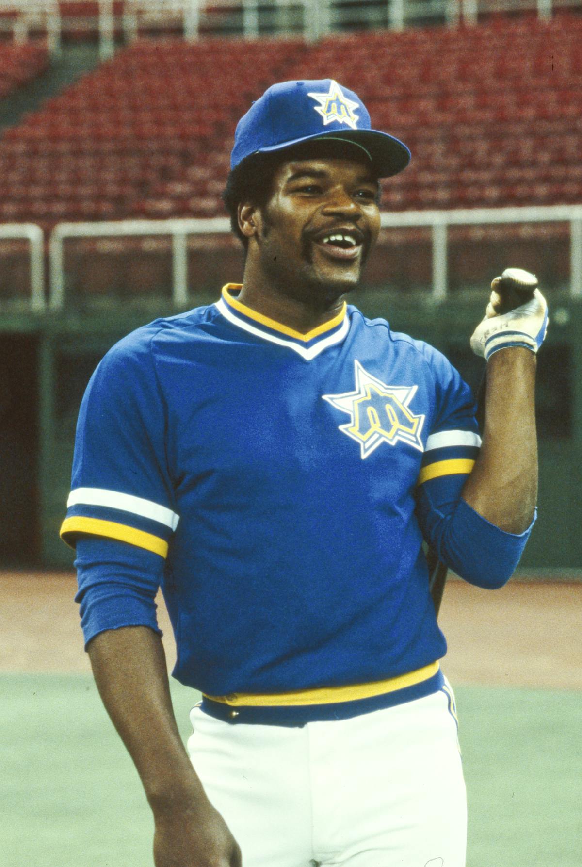 Dave Henderson in a blue uniform holding a ball