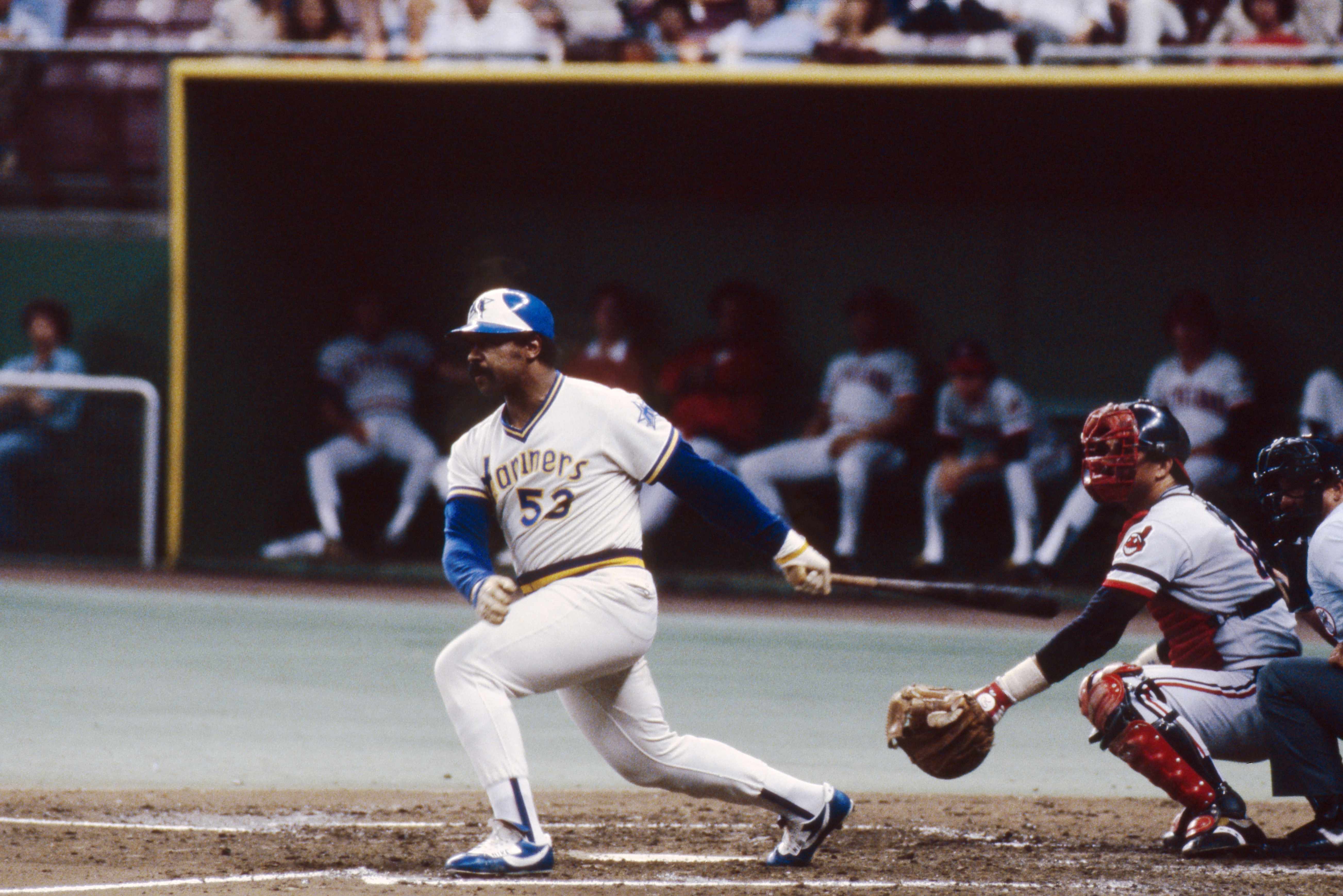 a baseball player swinging a bat at a ball