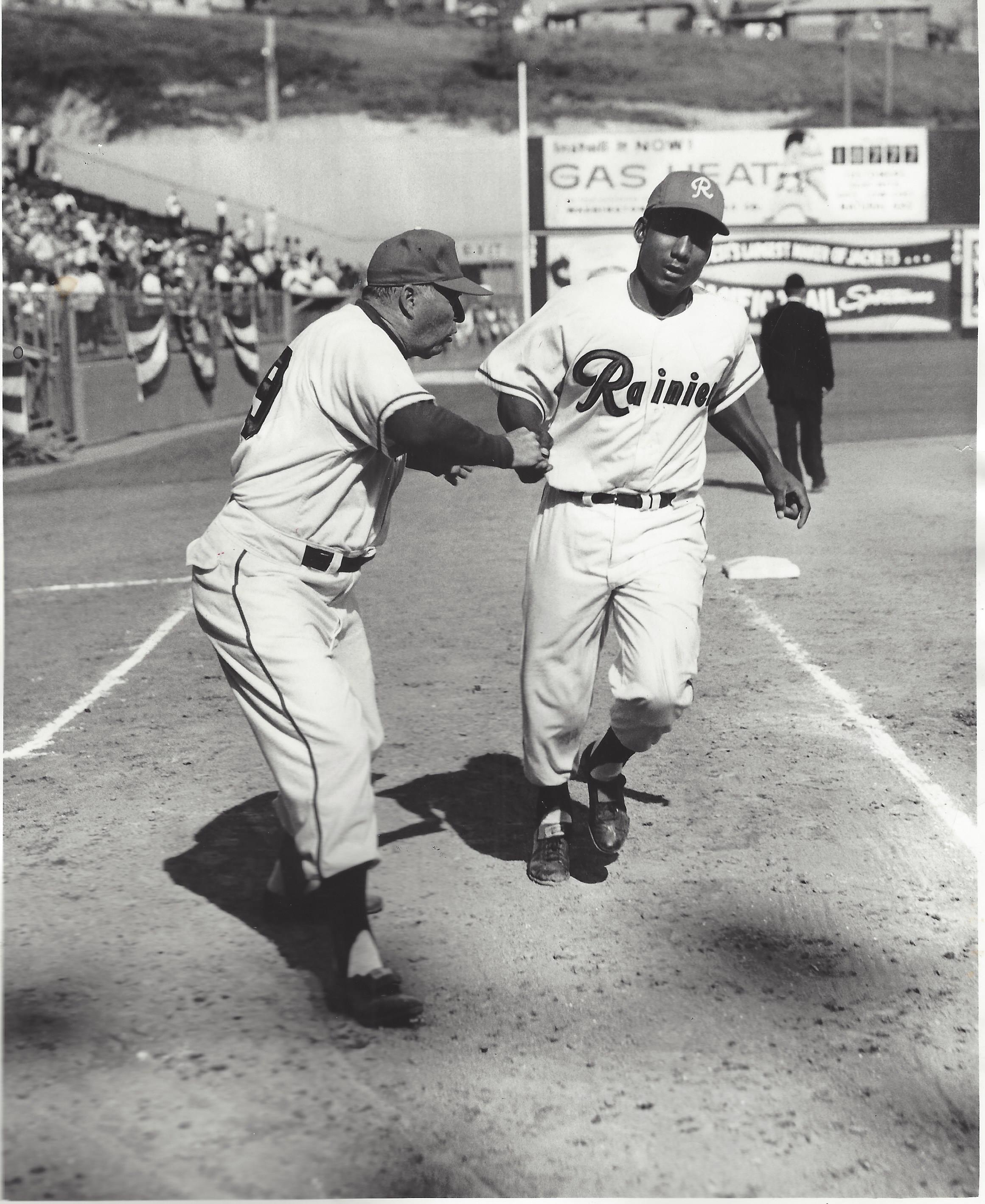 a group of baseball players standing on top of a field