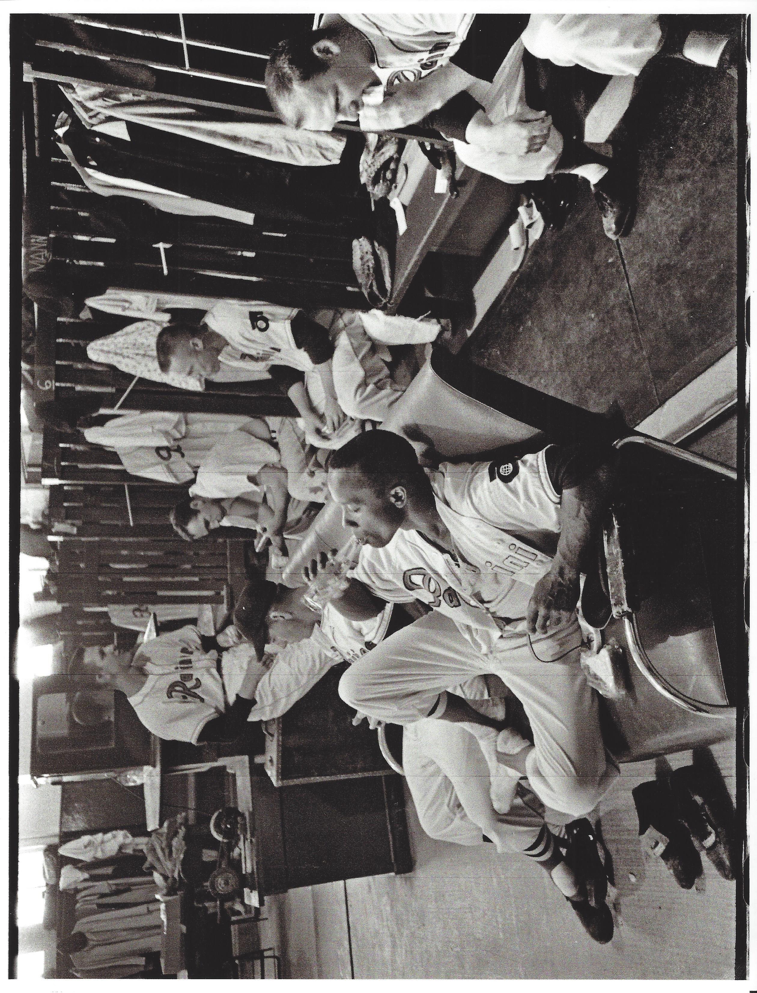 a vintage photo of a group of people sitting in chairs