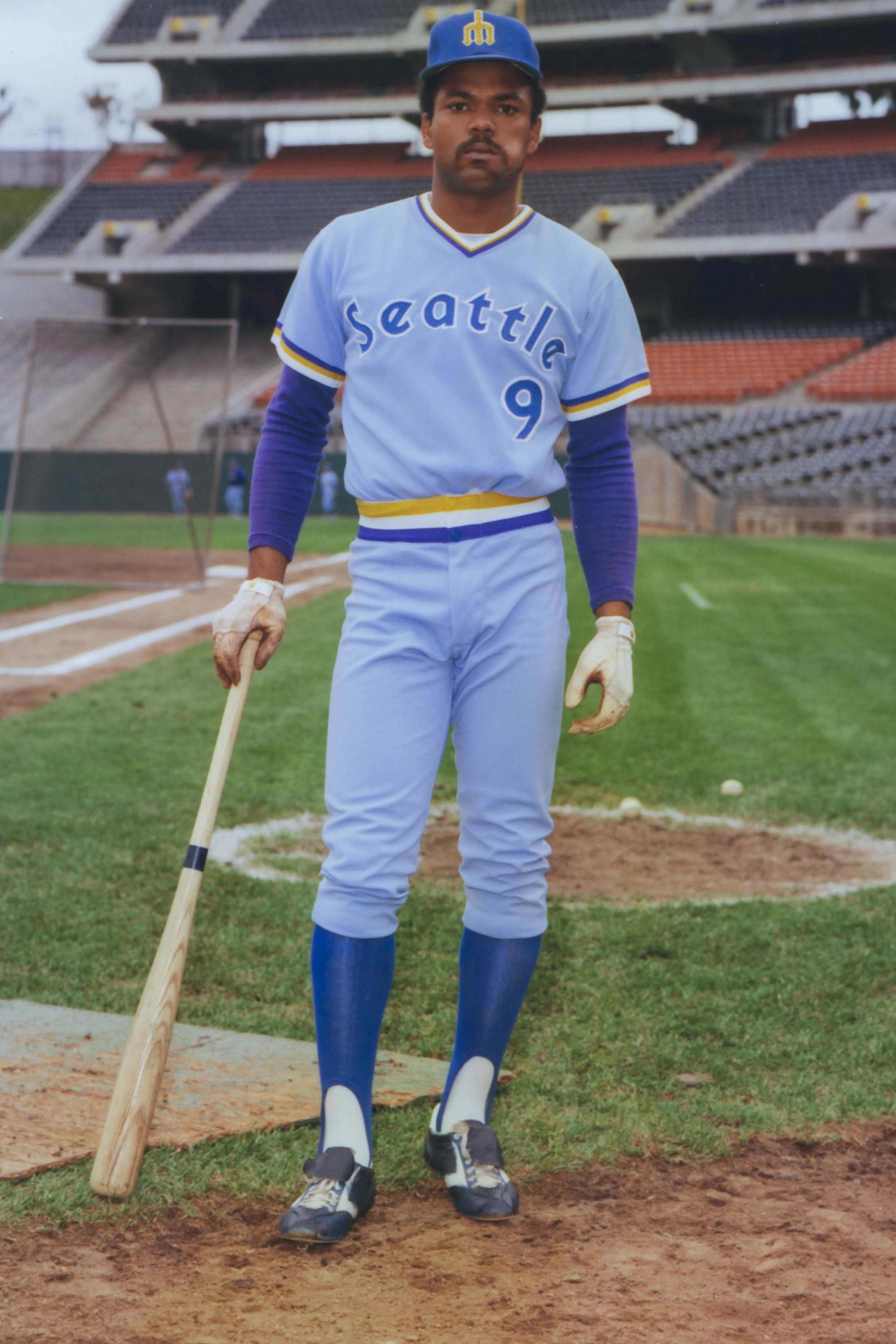 a baseball player holding a bat on a field