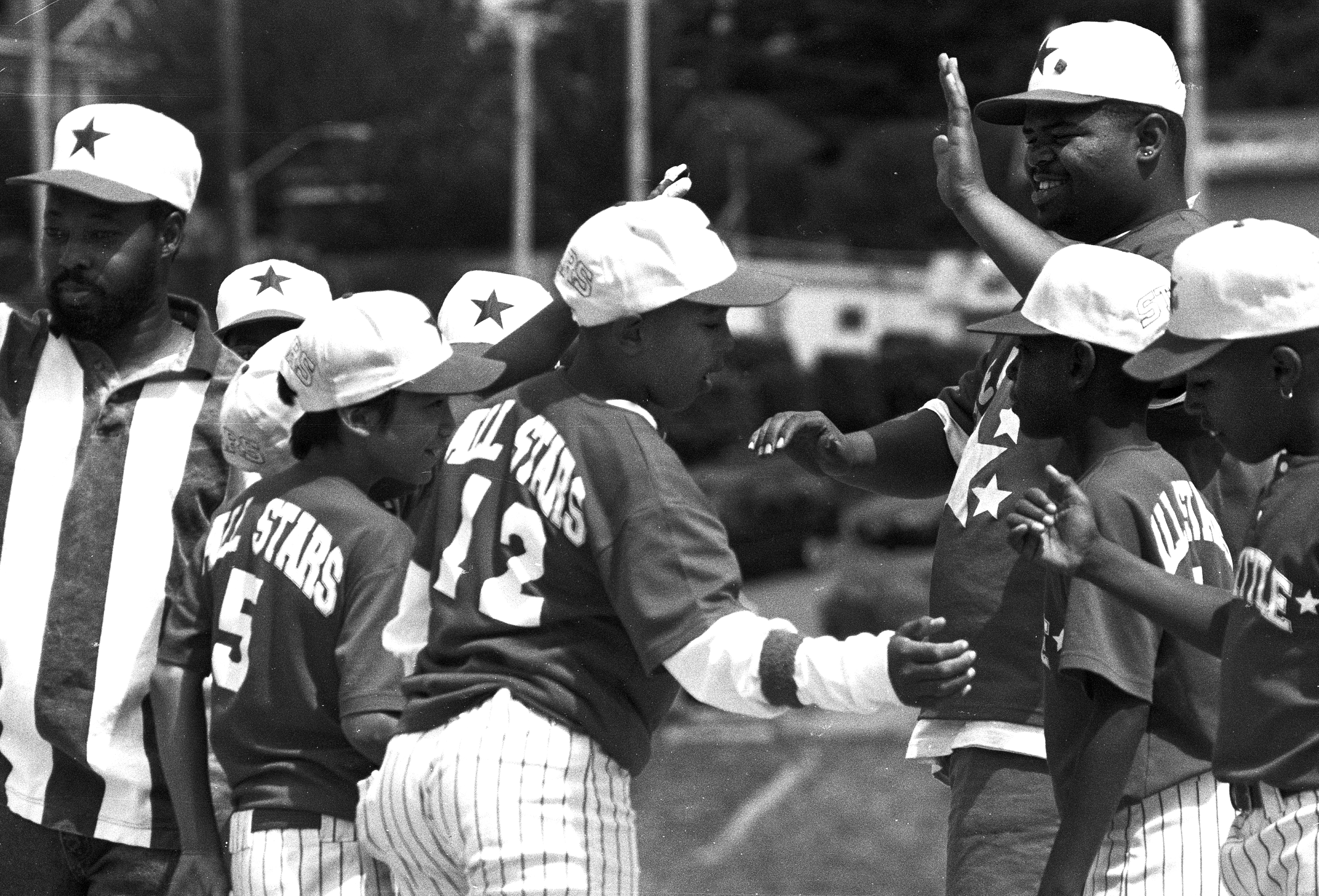 a group of baseball players standing on top of a field