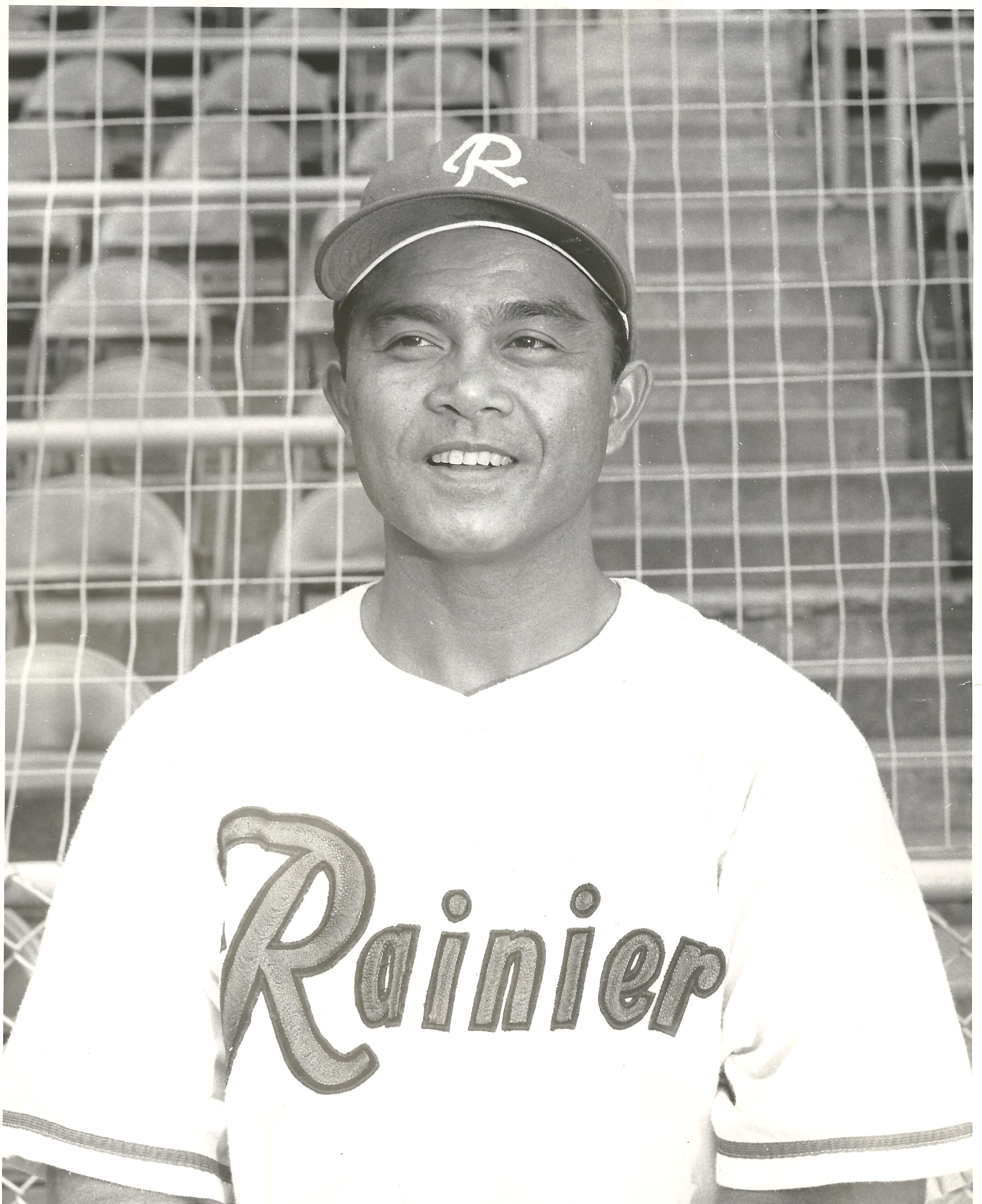 Bobby Balcena standing in front of a baseball player posing for a photo