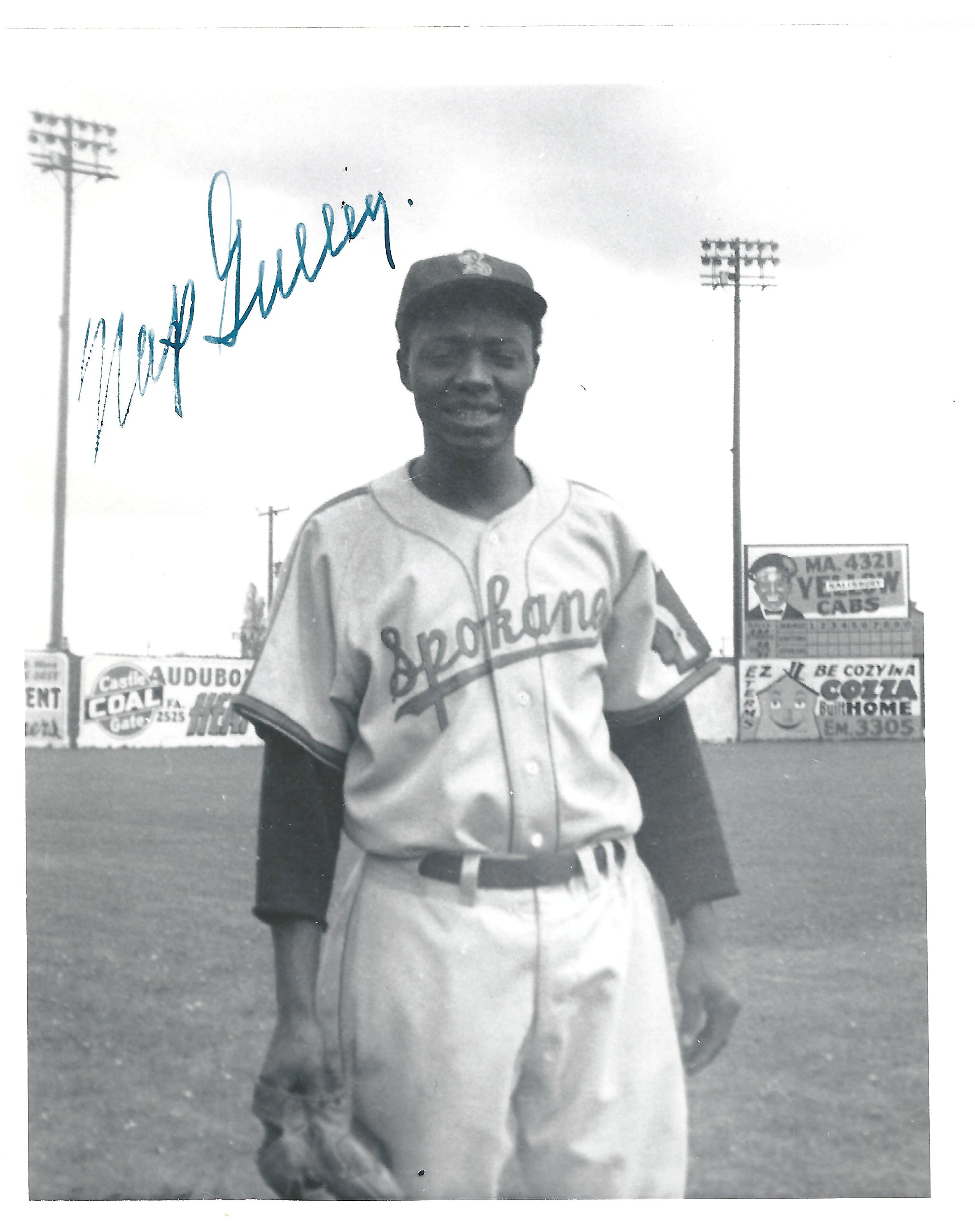 a man holding a sign posing for the camera