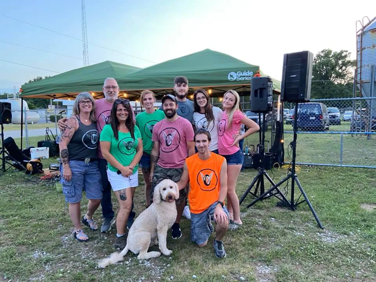 a group of people posing for a picture with a dog