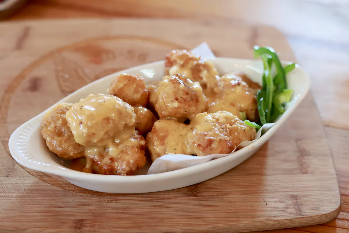 a plate of food sitting on top of a wooden table