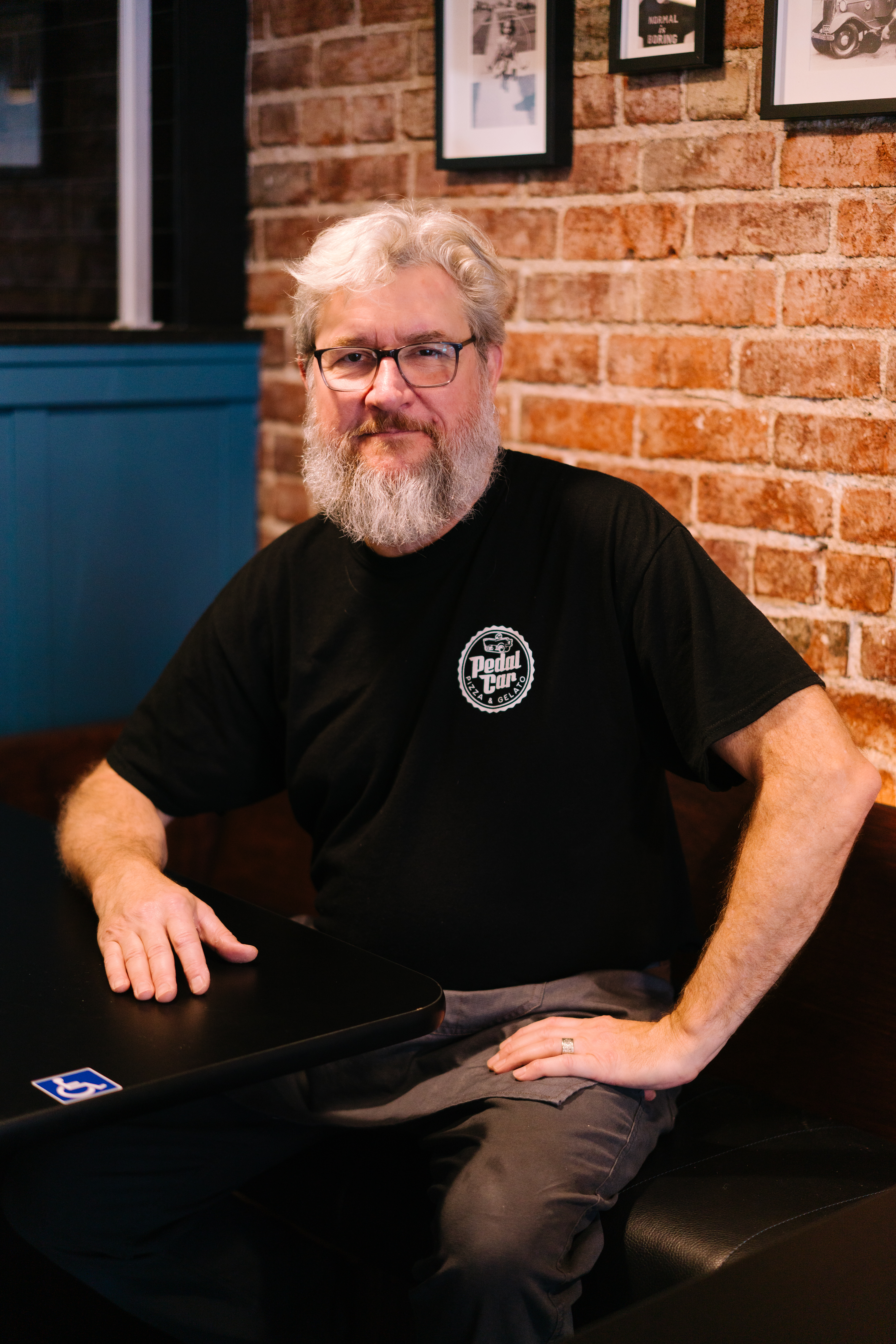 a man sitting in front of a laptop