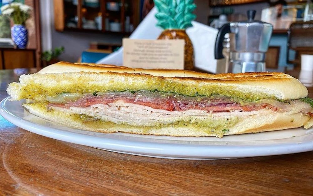 A delicious pressed sandwich at Tinta y Café filled with ham and pork representing the flavors of traditional Cuban cuisine