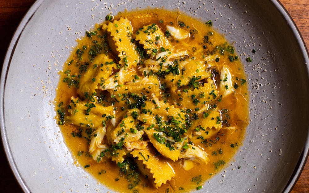 A close-up view of Jaguar Sun's Agnolotti pasta, showcasing the delicate folds of the pasta filled with savory ingredients, representing culinary artistry