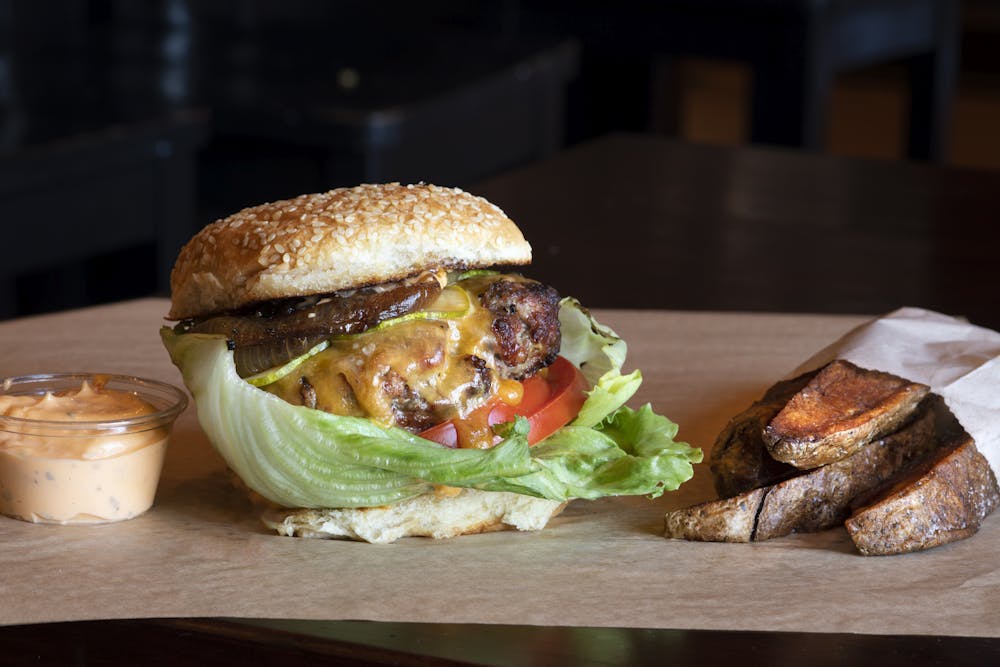 a close up of a sandwich sitting on top of a wooden table