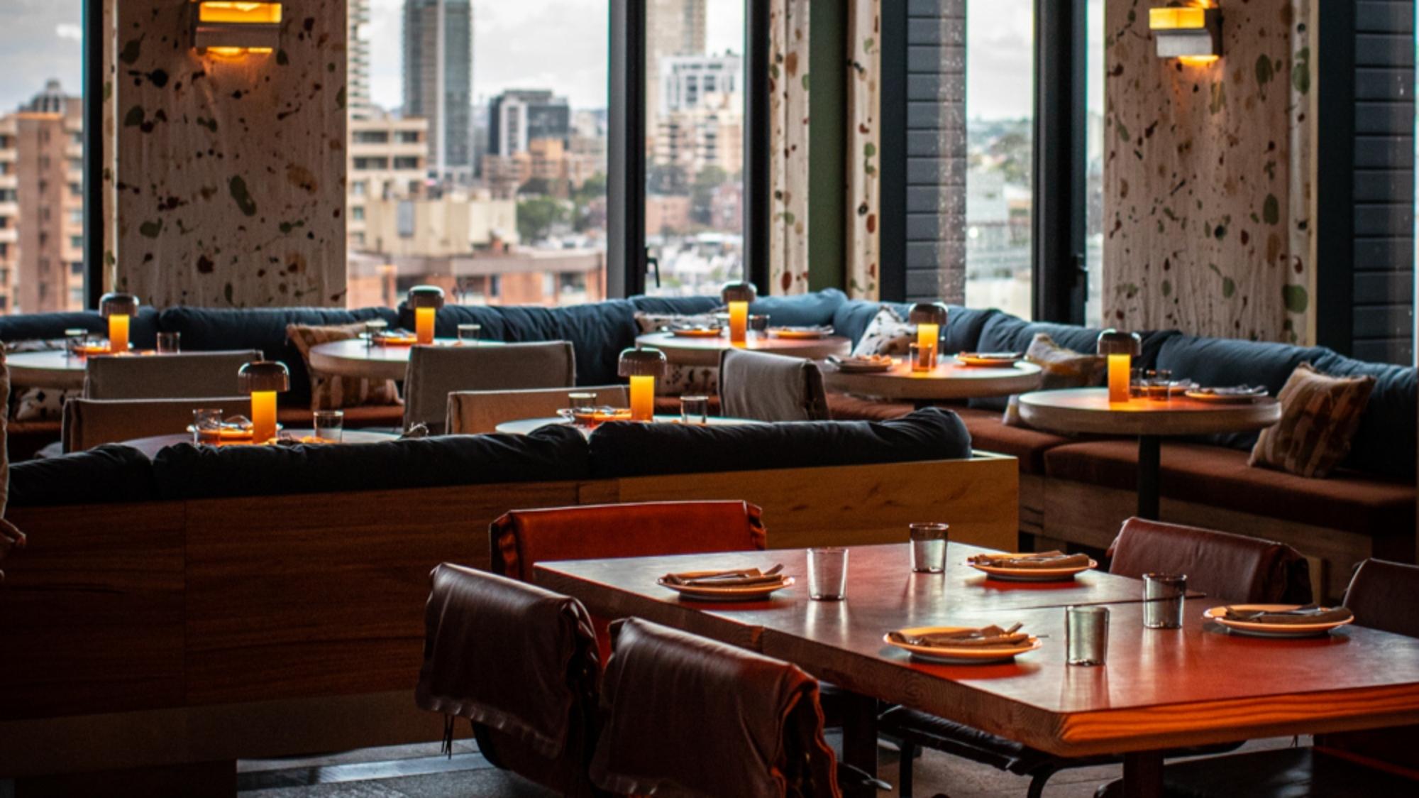 a table topped with lots of furniture and a large window