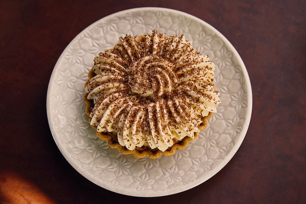 A plate with a fancy dessert that has chocolate inside