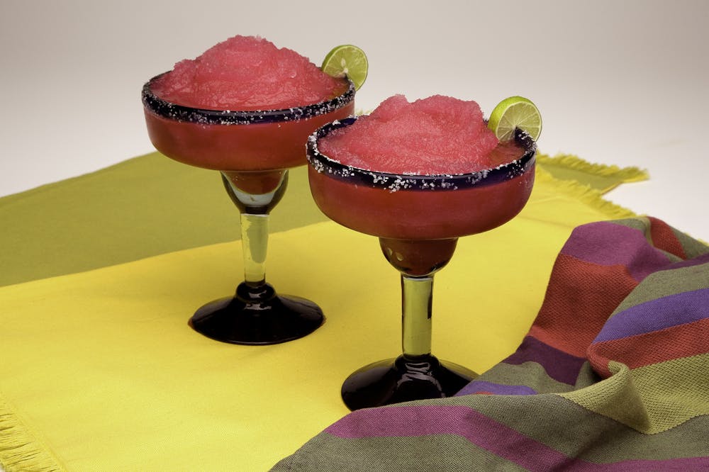 a glass of wine sitting on top of a table