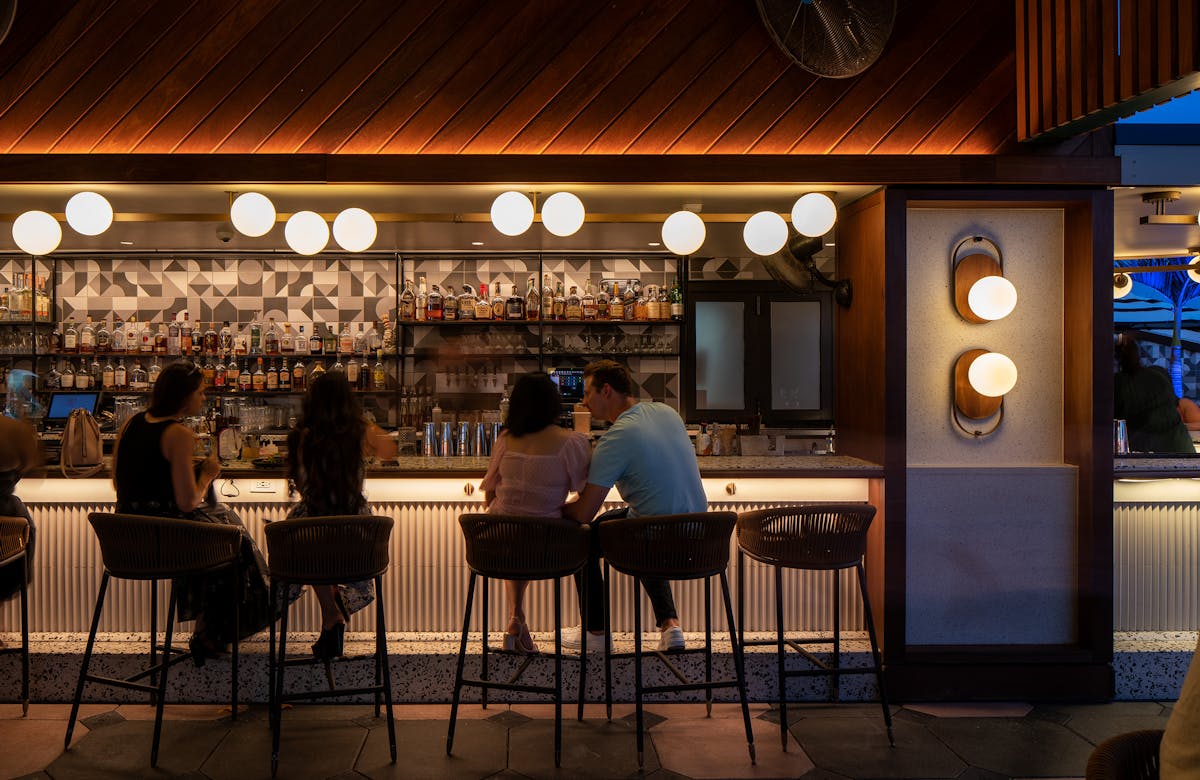a group of people sitting at a table in a restaurant