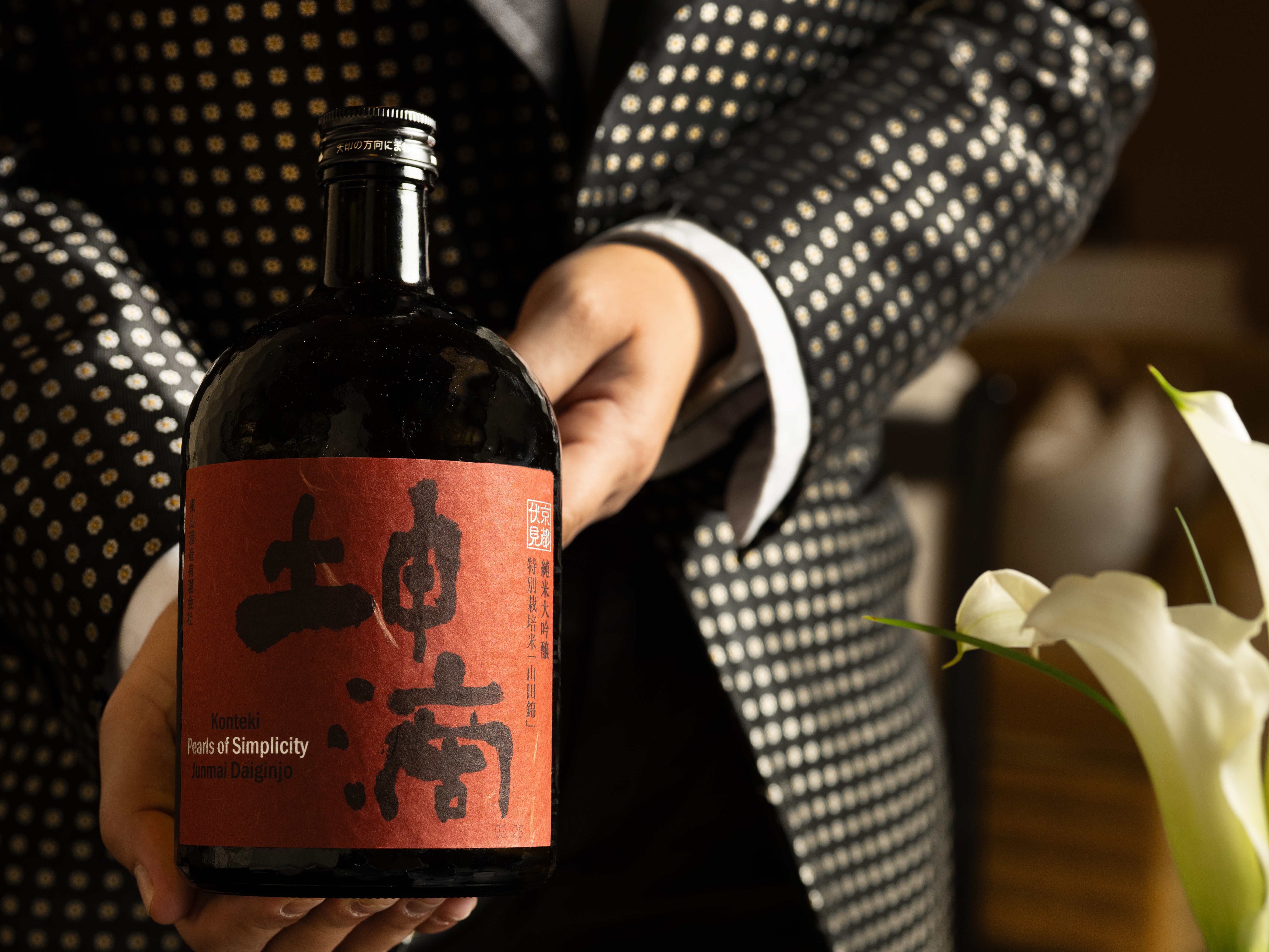 a person holding a bottle of alcohol