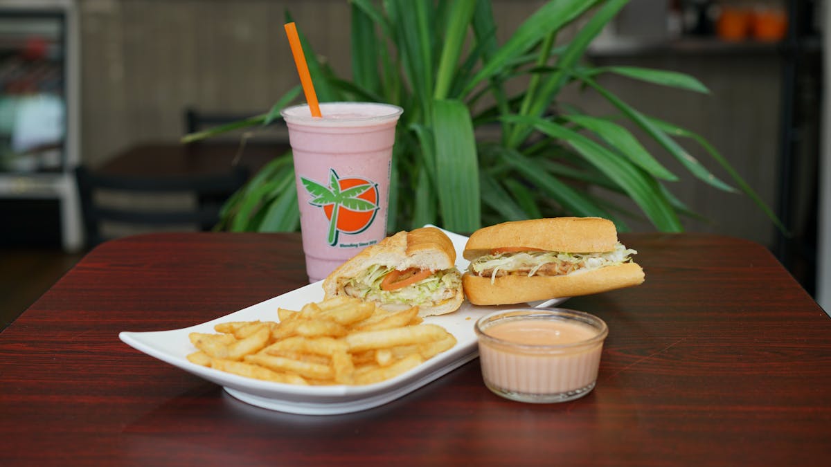 a juice and a sandwich on a plate