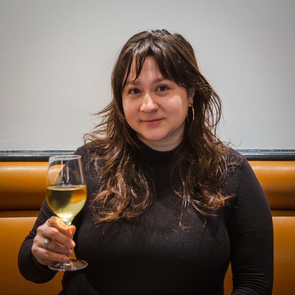 a woman holding a glass of wine