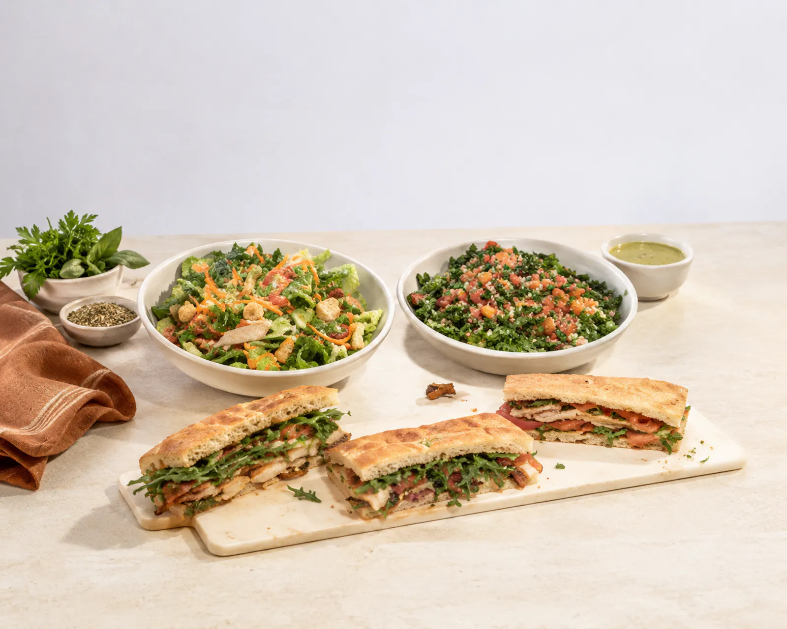 A Cos&igrave; catering spread of breakfast items, sandwiches, salads and sides ready for an office meeting