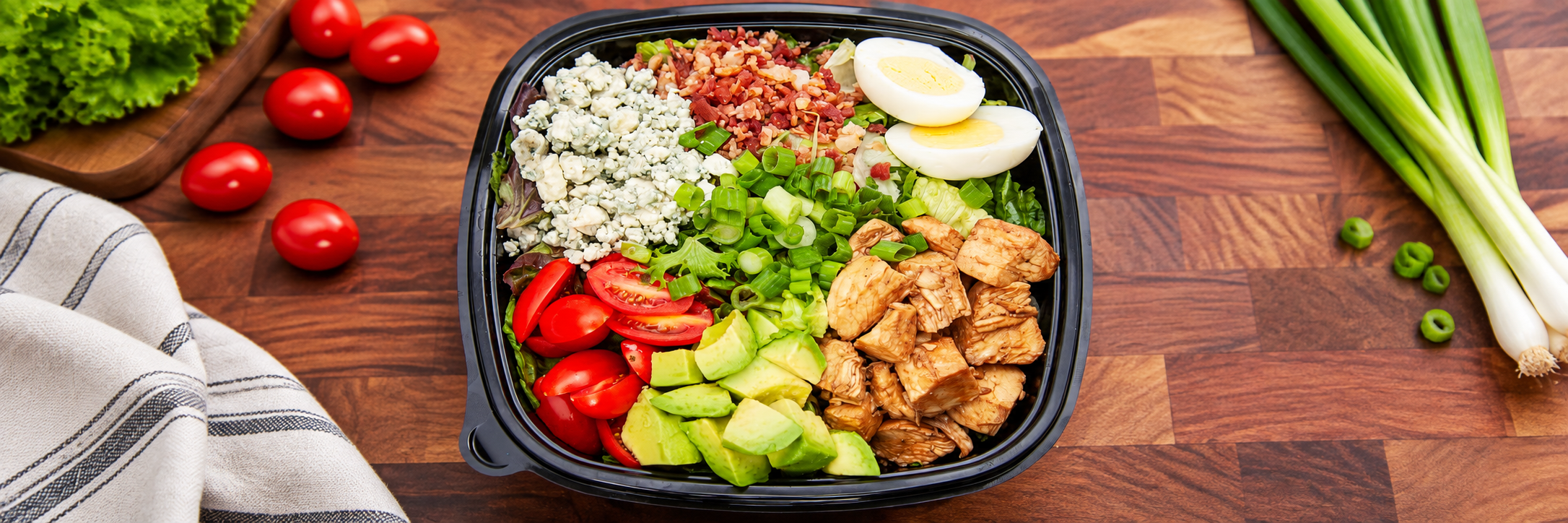 A Cos&igrave; Cobb salad with chicken, bacon, egg, tomatoes, and bleu cheese