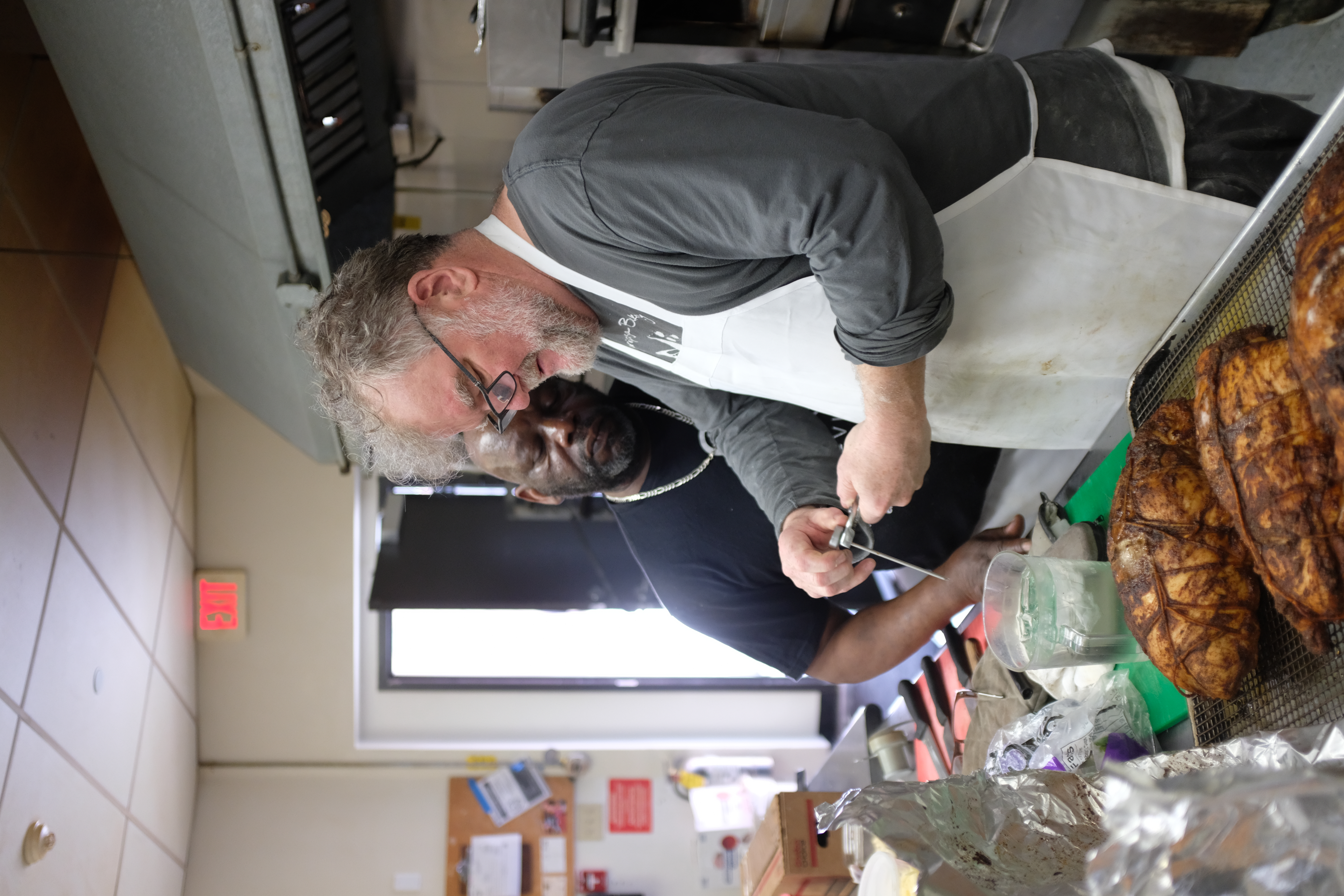 a man standing in a kitchen preparing food