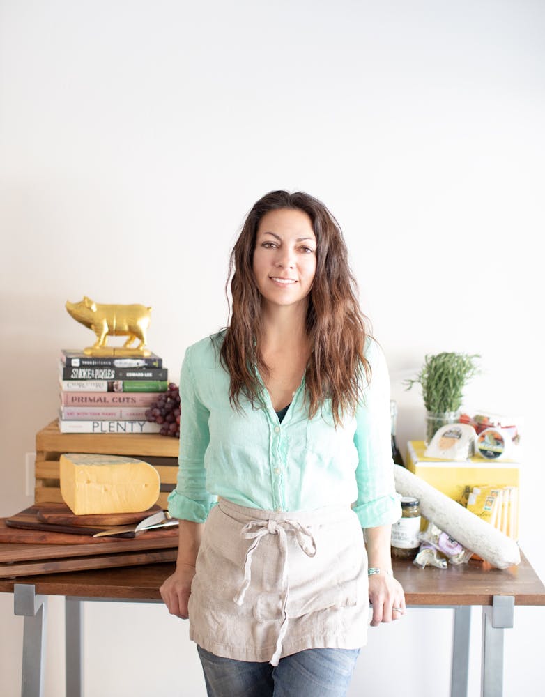 a woman standing in front of a table