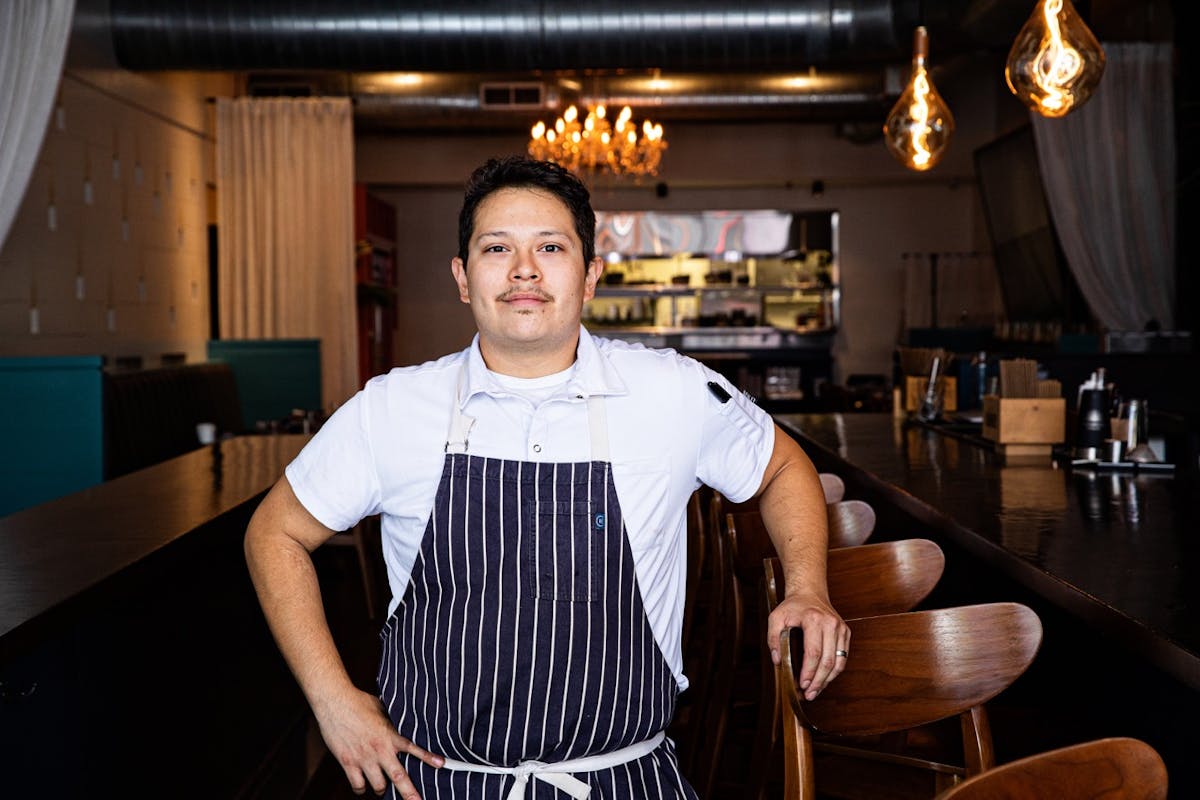 a man standing in front of a bar