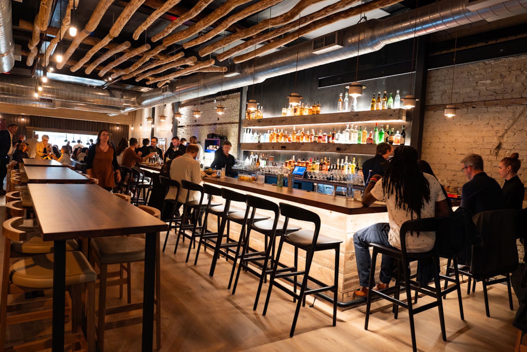 a group of people sitting at a table in a restaurant