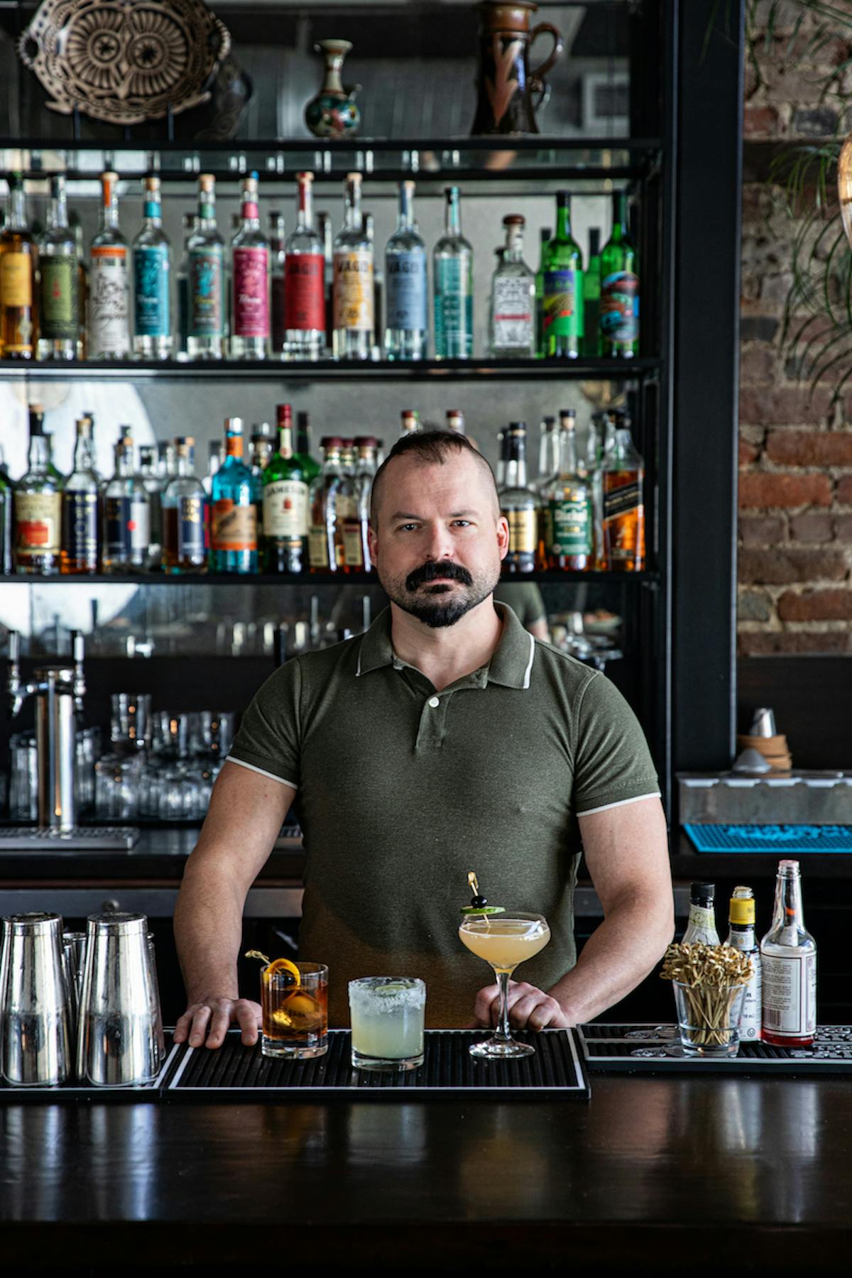 a man drinking a glass of wine