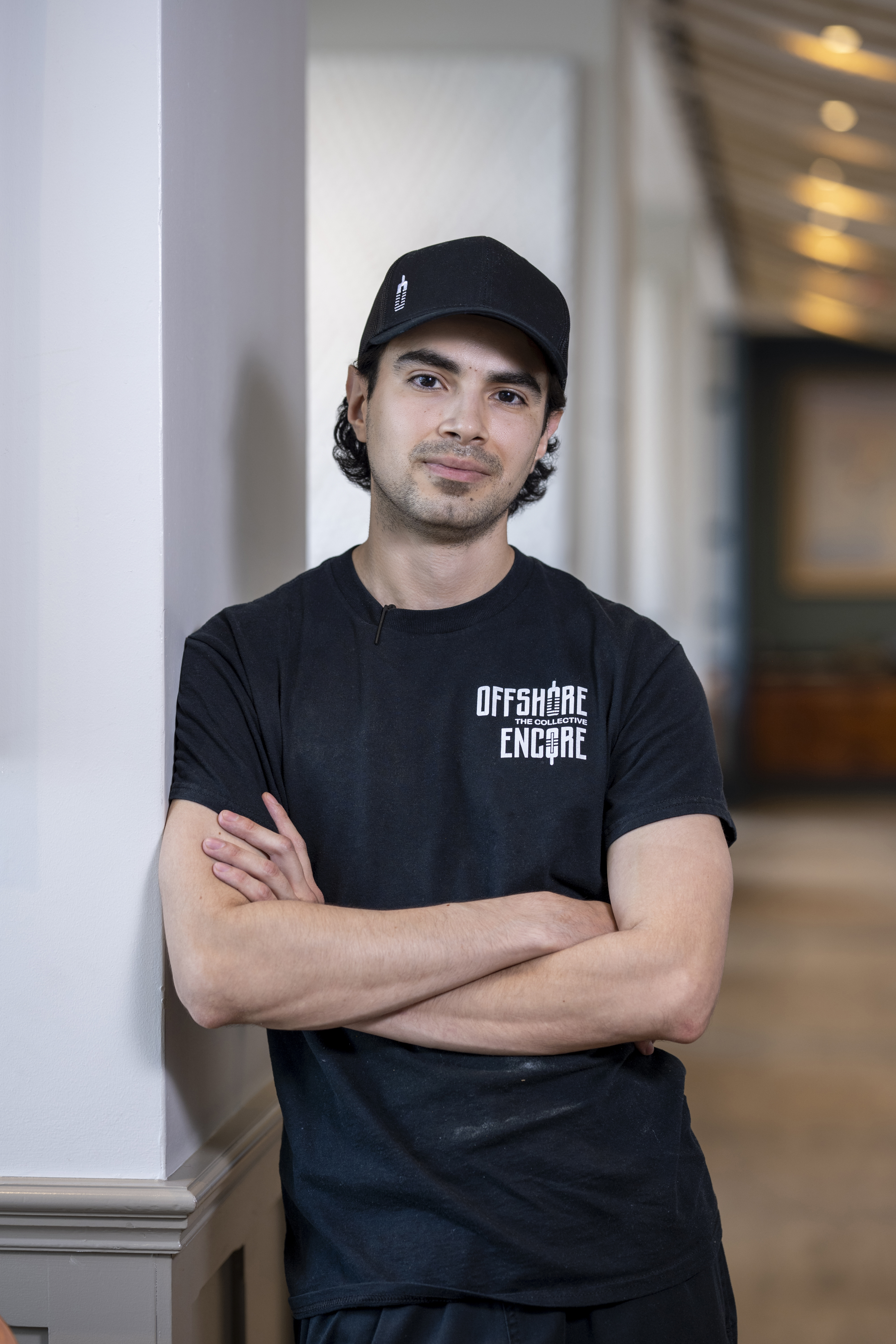 a man wearing a black hat and black shirt