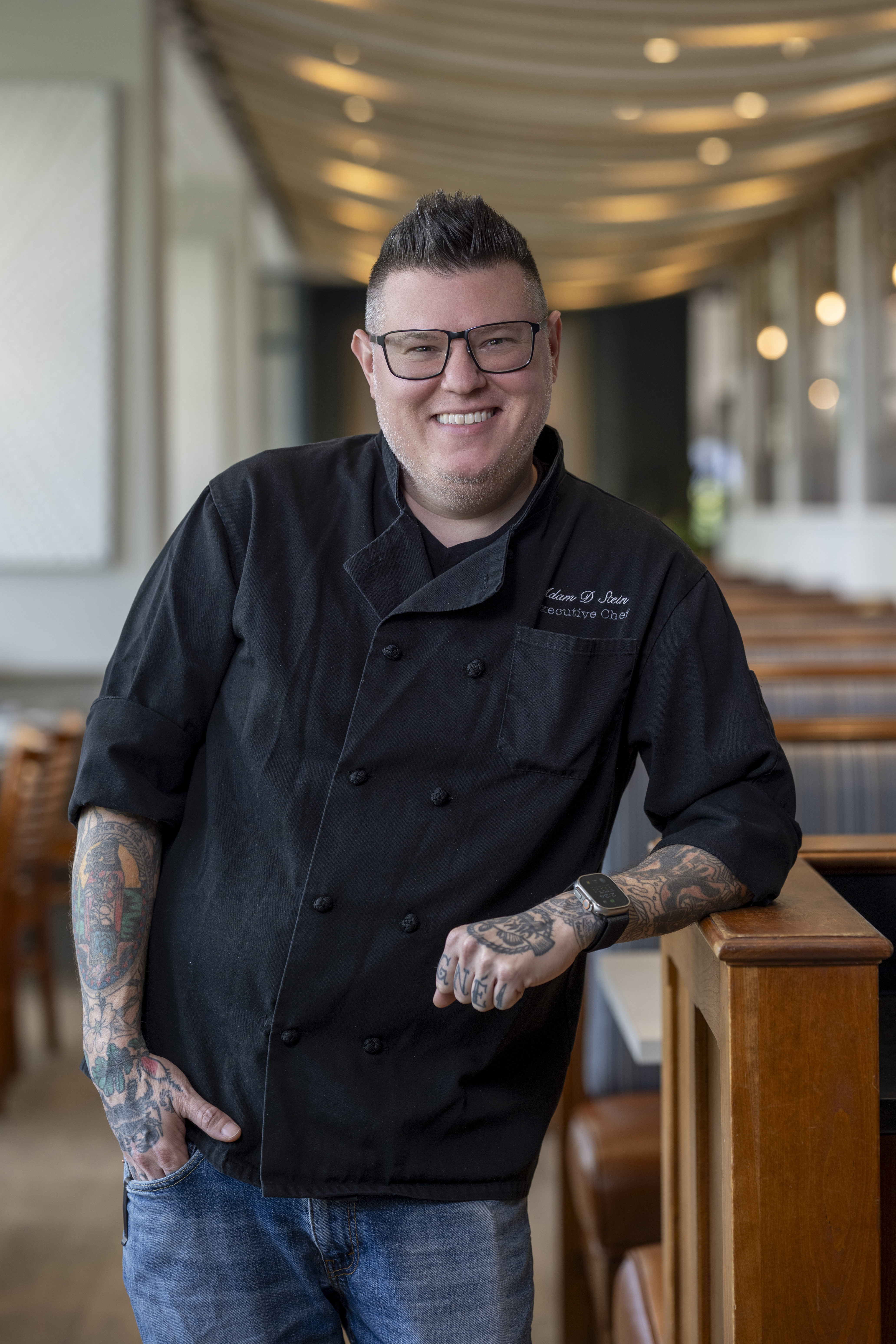 a man wearing a black chef coat