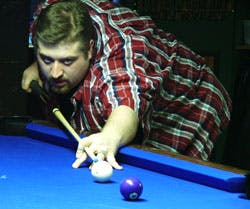 a person sitting at a table with a blue ball