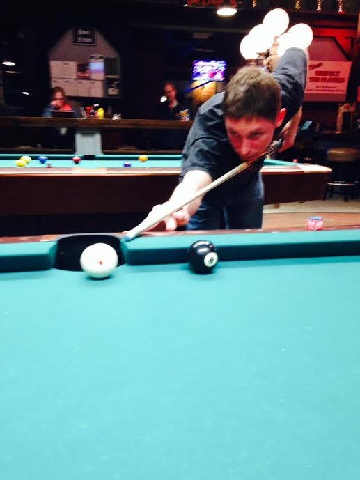 a man sitting at a table with a blue ball