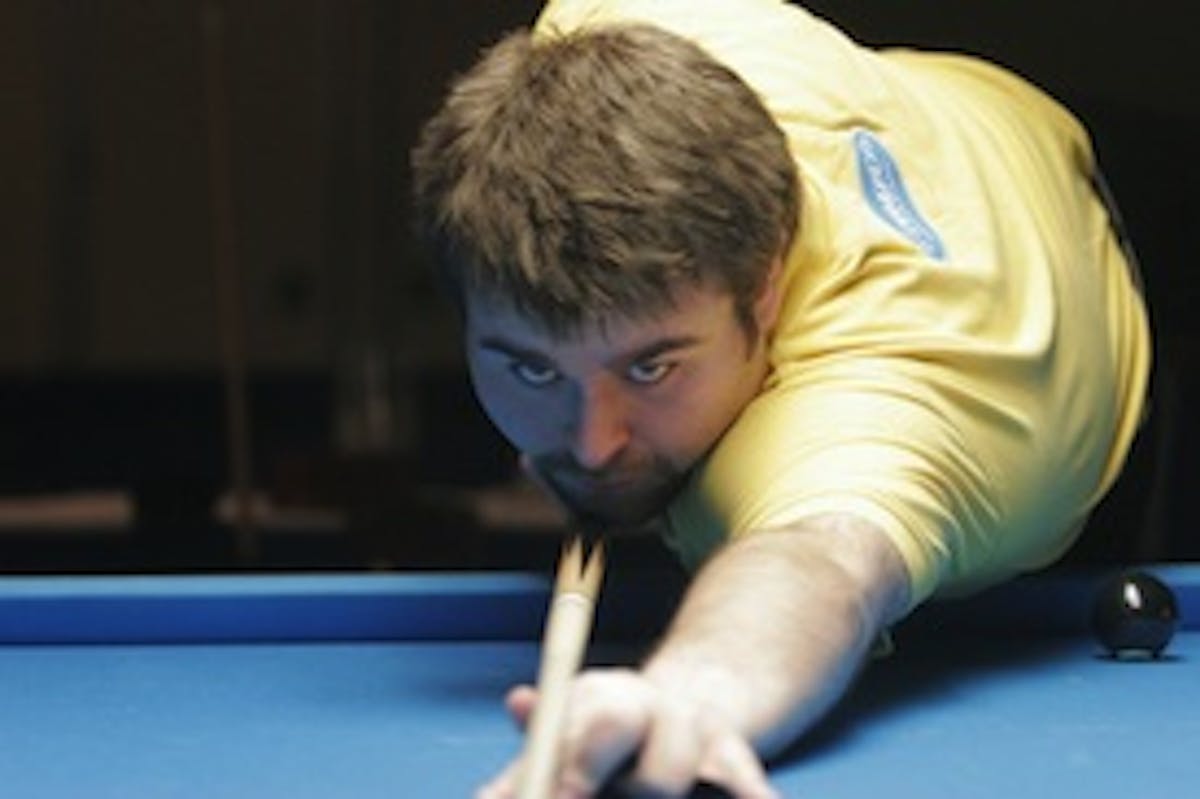 a person sitting at a table with a blue ball