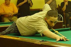 a person sitting at a table with a ball in a room