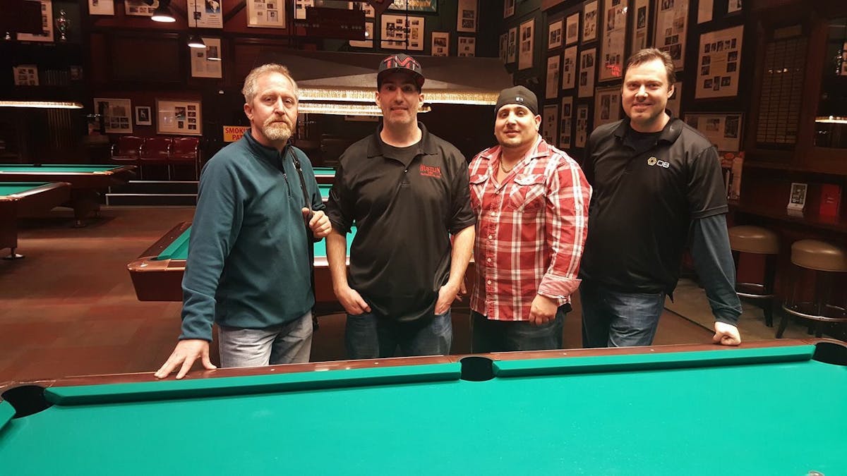 a group of people sitting at a table with a ball in a room